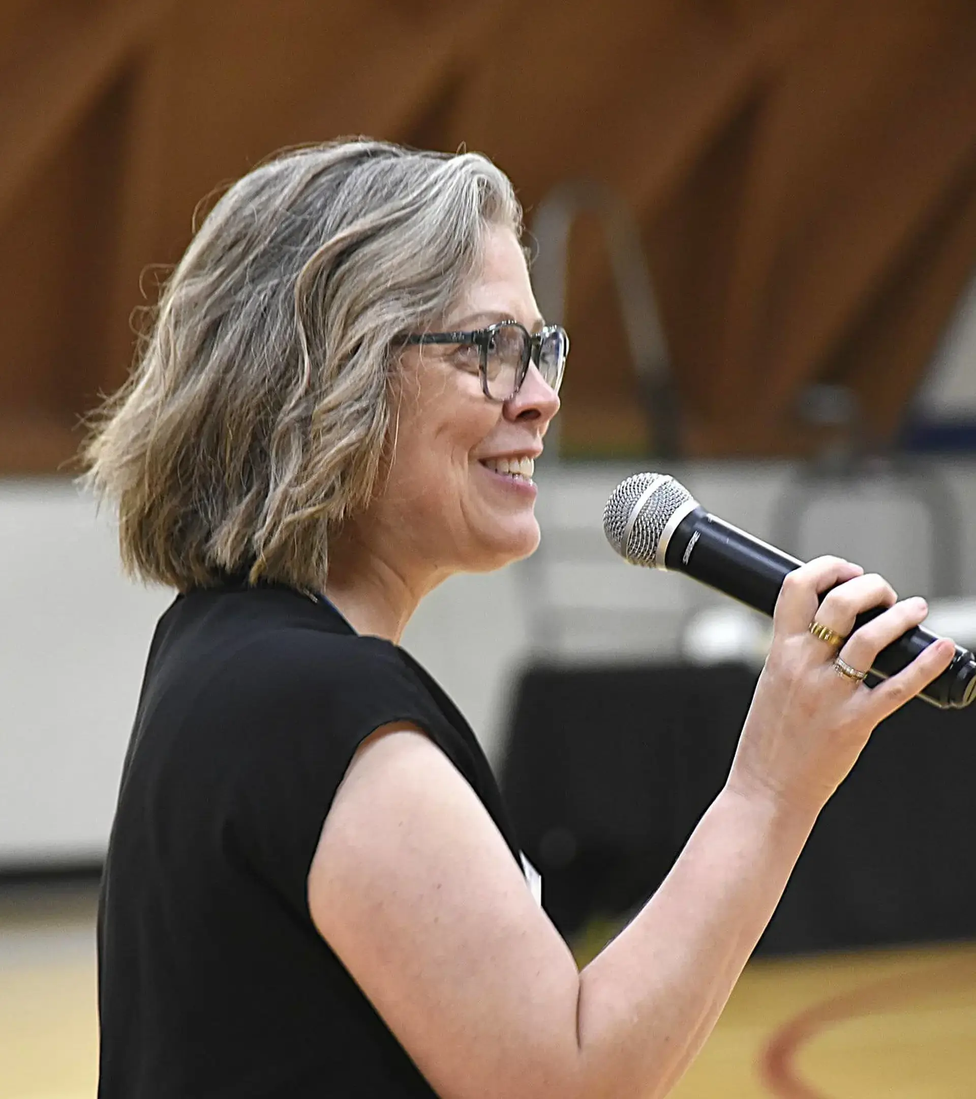 Jane Roth speaking into microphone