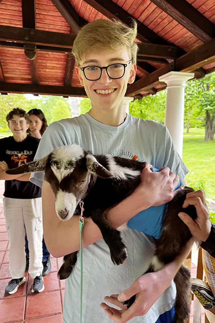 Student holding lamb