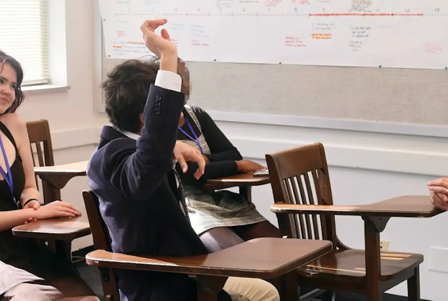 Student raising hand in class