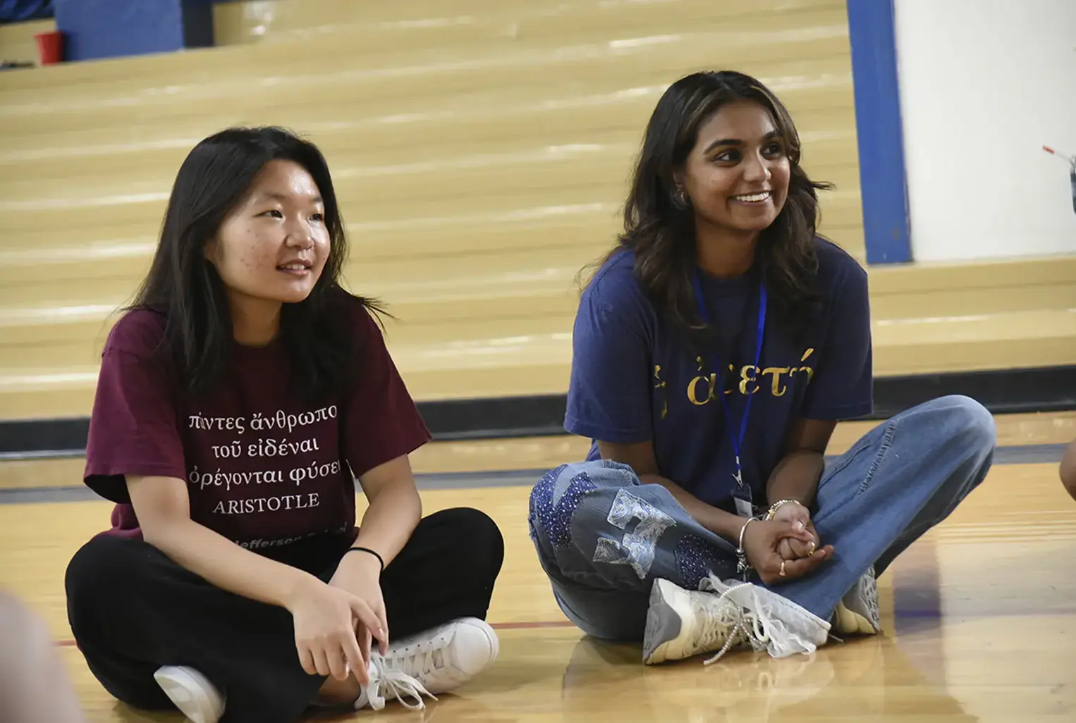 Students sitting cross-legged on floor